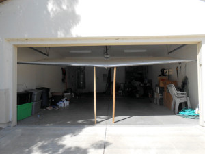 Repair bent garage door in Sacramento.